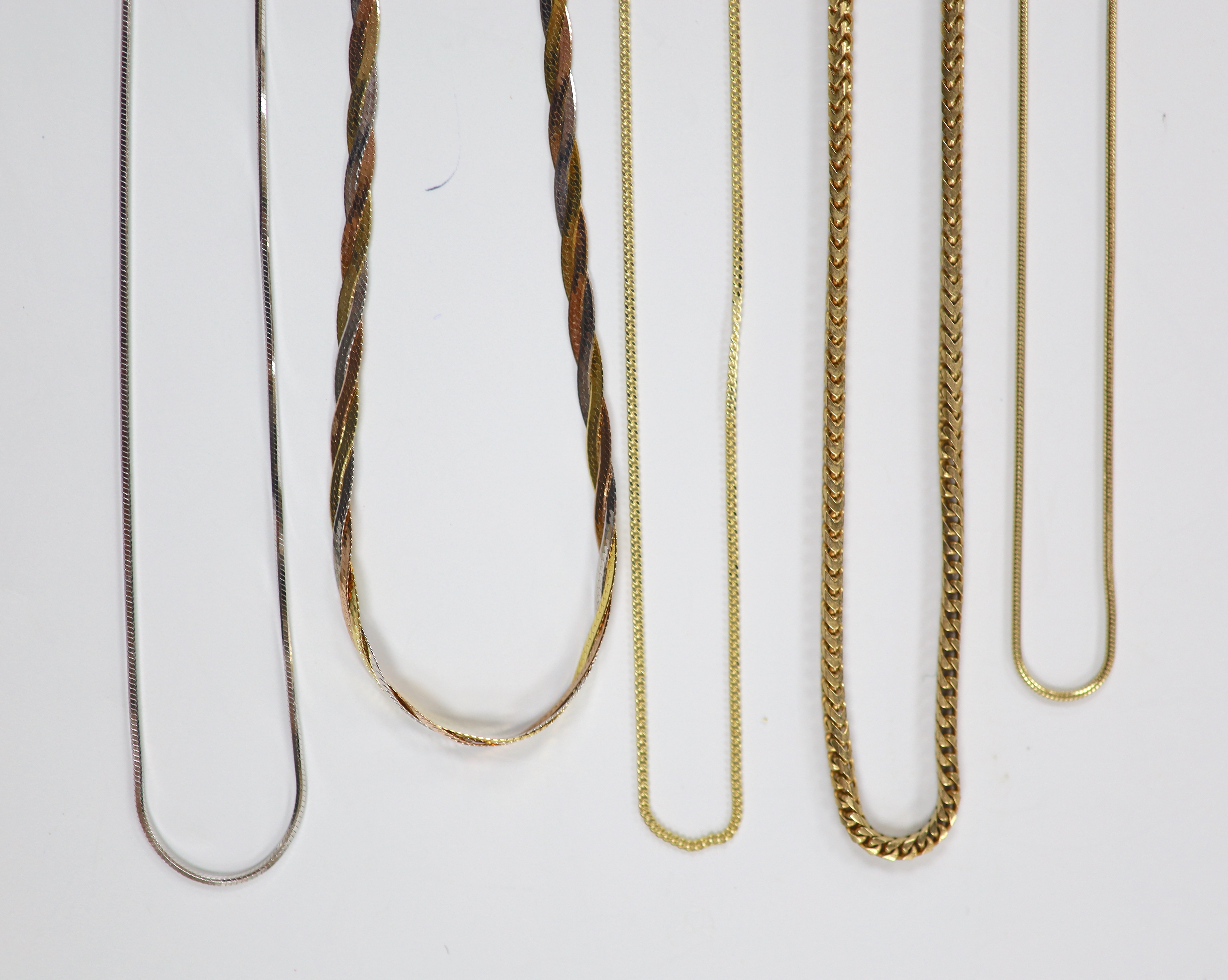 Four assorted modern 9ct gold chains including white gold and one 375 chain, longest 44cm, 19.6 grams.